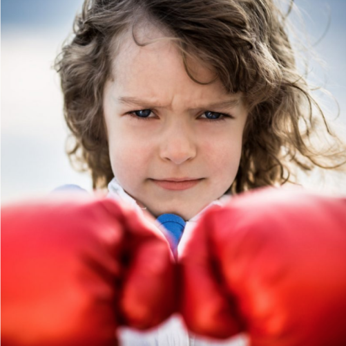 A little girl showing her boxing globes